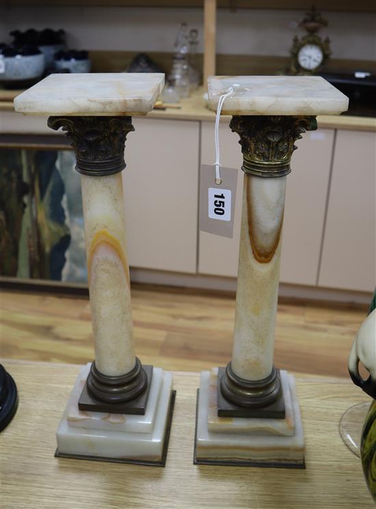 A pair of small onyx pedestals height 44cm